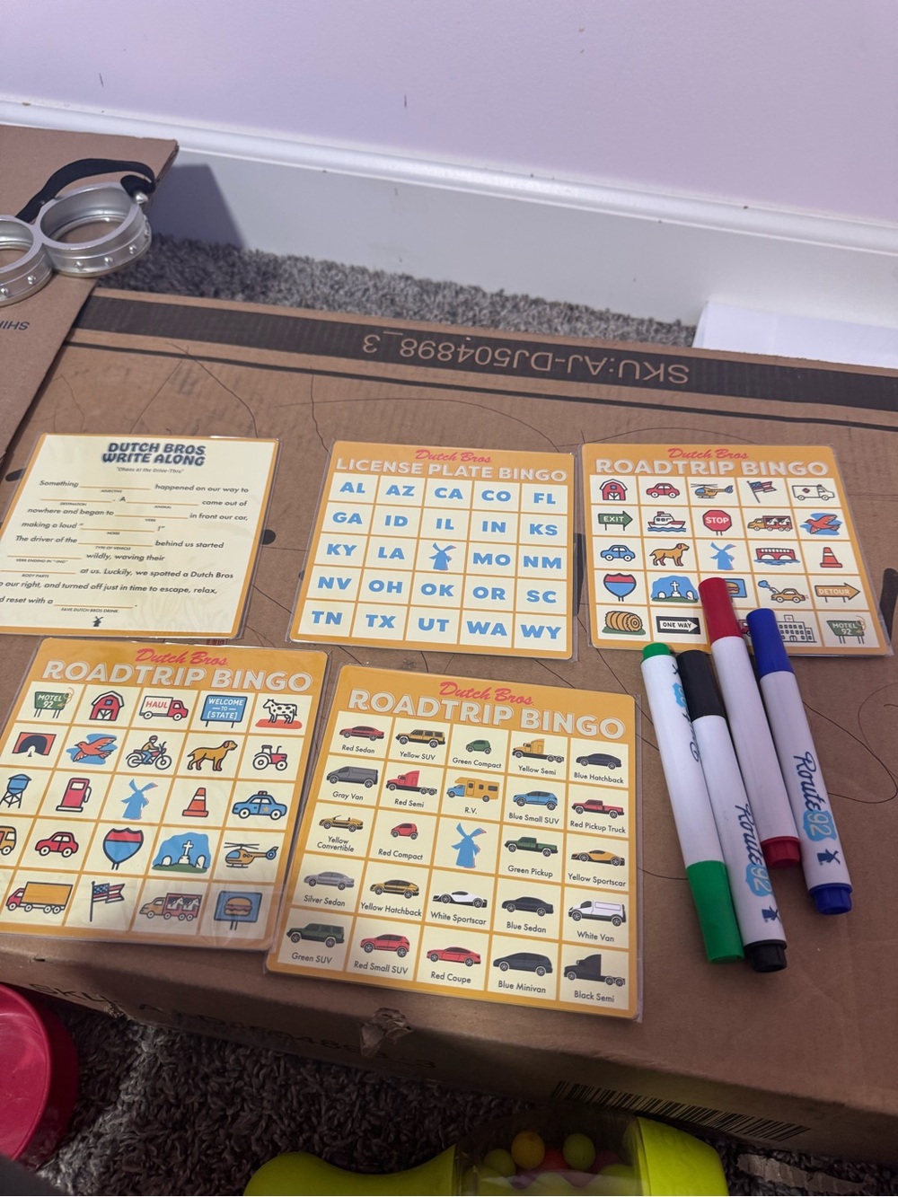 Dutch Bros Yellow Roadtrip Bingo Cards with Red Blue Green Black Markers